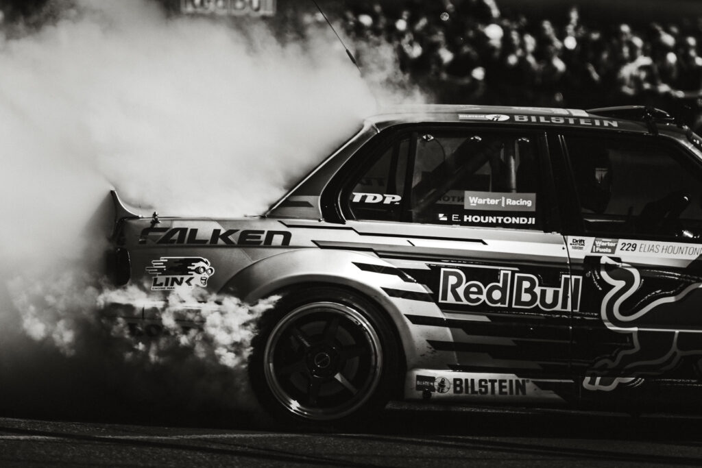 Red Bull Driftbrothers (NL) burning out tyres black and white photo by ondrej kolacek