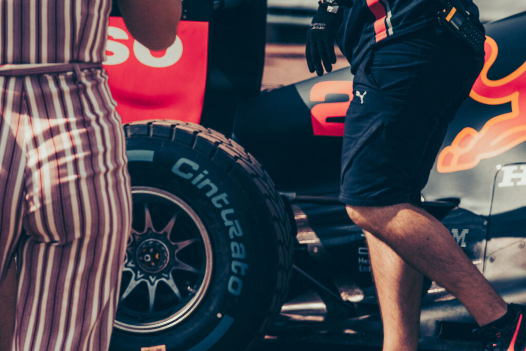 Aston Martin Red Bull Racing girl watching the mechanics at work