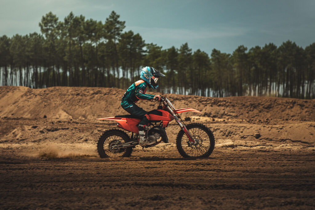 Young guy racing is Motocross Bike at Bud Racing track in france.