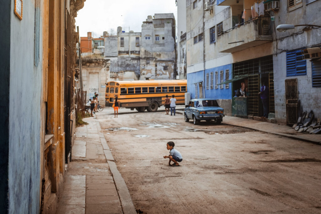 Small kid playing on the streets of havanna by ondrej kolacek