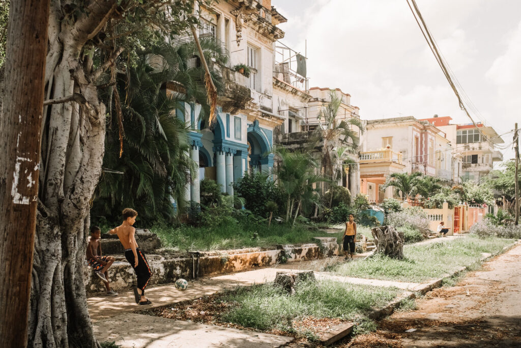 Kids playing football in a neighborhood of havanna by ondrej kolacek