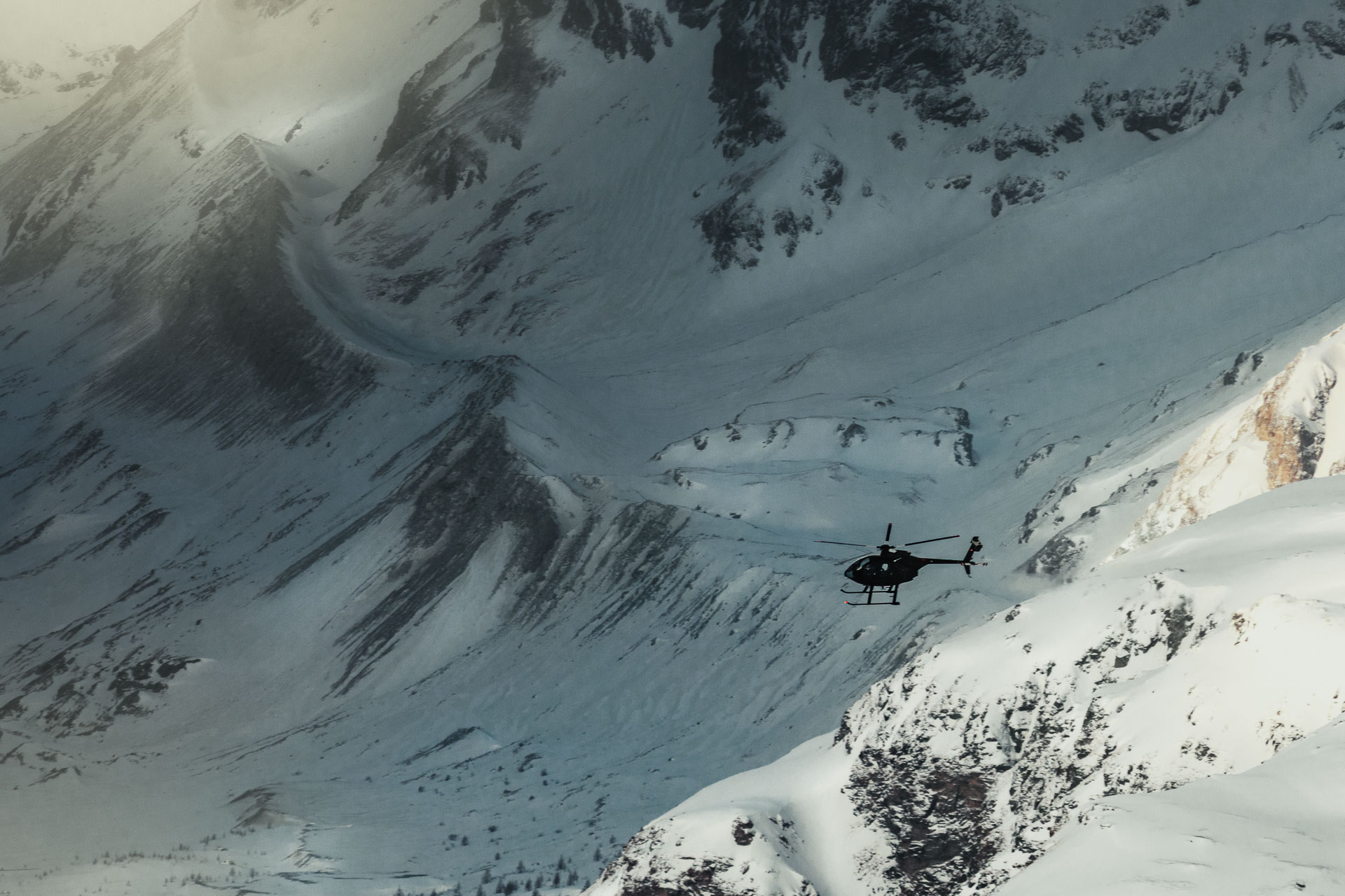 Helicopter In flying in front of a snow covered mountain by ondrej kolacek