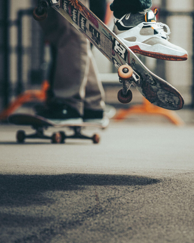 Skateboarder making a trick waring dc shoes by Ondrej Kolacek