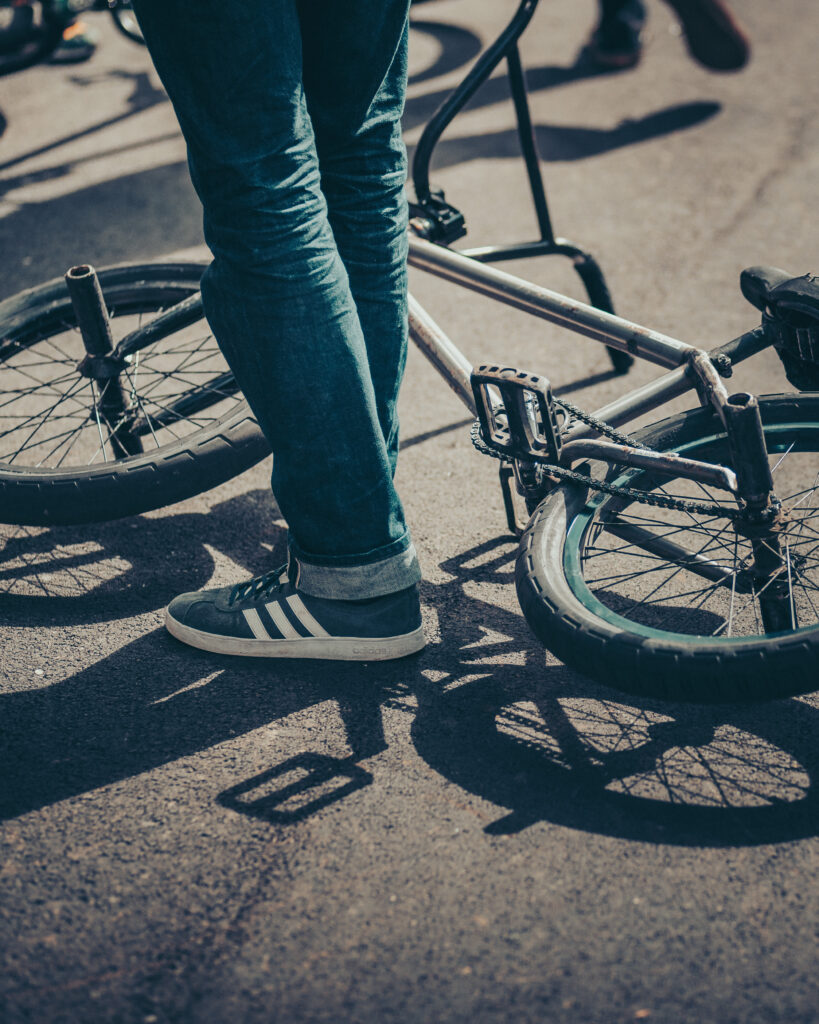 Flint Harrison standing next to his BMX bike by Ondrej Kolacek