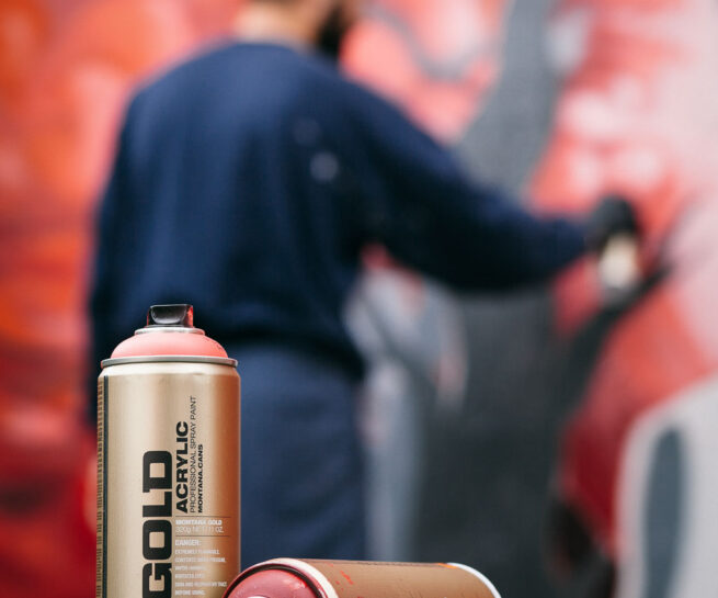 Graffiti artist is spraying a wall by Ondrej Kolacek